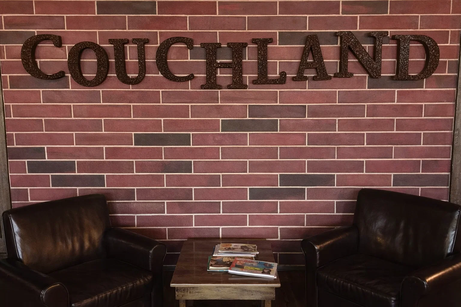 CouchLand Coffee House interior with leather armchairs and brick walls