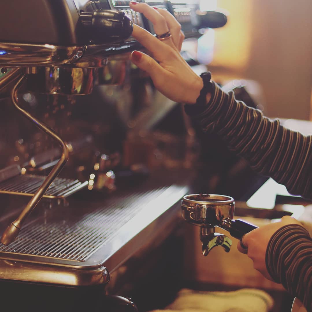 Barista pulling a shot at the espresso machine
